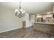 Open-concept kitchen and dining area with a modern chandelier and wood breakfast bar at 1715 E El Parque Dr, Tempe, AZ 85282