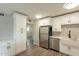 This kitchen features stainless steel appliances, white cabinets, quartz countertops, and a farmhouse sink at 1715 E El Parque Dr, Tempe, AZ 85282