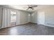 Open living area with wood-look flooring, fan, and lots of natural light at 1715 E El Parque Dr, Tempe, AZ 85282