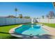 A backyard featuring a sparkling pool, slide, artificial grass, and nice fencing at 1715 E El Parque Dr, Tempe, AZ 85282