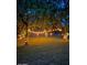 Picturesque backyard with trees adorned with string lights, creating a magical ambiance at 17335 W Cheryl Dr, Waddell, AZ 85355