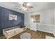 Bedroom with a modern design, decorative wall and wood-look floors at 17335 W Cheryl Dr, Waddell, AZ 85355