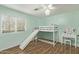 Bedroom featuring wood-look floors and a bunk bed with slide at 17335 W Cheryl Dr, Waddell, AZ 85355