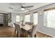 Elegant dining room with hardwood floors, modern lighting, and seating for six at 17335 W Cheryl Dr, Waddell, AZ 85355