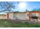 Back of building featuring a pergola, red door, and convenient access, ideal for outdoor activities at 17335 W Cheryl Dr, Waddell, AZ 85355