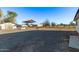 Expansive gravel yard with sheds, providing versatile space for storage and outdoor activities at 17335 W Cheryl Dr, Waddell, AZ 85355