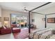 Bedroom with a canopy bed, ceiling fan, and sliding glass doors to an outdoor patio at 17366 E Via Del Oro St, Fountain Hills, AZ 85268