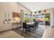 Elegant dining room with a large table, modern lighting, and sliding glass doors to the outdoor patio at 17366 E Via Del Oro St, Fountain Hills, AZ 85268