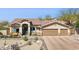 Single-story home showcasing desert landscaping, a two-car garage, and a tiled roof at 17366 E Via Del Oro St, Fountain Hills, AZ 85268