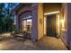 Charming front porch featuring a decorative metal door, lush plants, and a cozy bench at 17366 E Via Del Oro St, Fountain Hills, AZ 85268