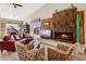 Stylish living room with modern fireplace, comfortable seating, and piano at 17366 E Via Del Oro St, Fountain Hills, AZ 85268