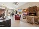 Bright living room featuring a fireplace, red leather sofa, grand piano, and tiled floors at 17366 E Via Del Oro St, Fountain Hills, AZ 85268