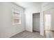 Bright bedroom featuring neutral carpet, a closet with sliding doors and a window with blinds at 18334 W Desert Holw Dr, Wittmann, AZ 85361