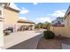 Spacious backyard featuring a low-maintenance landscape with desert rock and mature palm trees at 1893 S Sinova S Ave, Gilbert, AZ 85295