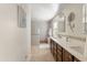 Bright bathroom featuring double sinks with dark wood cabinets and tiled walk-in shower and separate soaking tub at 1893 S Sinova S Ave, Gilbert, AZ 85295