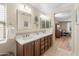 Bathroom featuring double sinks with dark wood cabinets, decorative mirrors, and tile flooring at 1893 S Sinova S Ave, Gilbert, AZ 85295