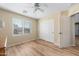 This bedroom features a ceiling fan, a window with blinds, and a closet with sliding doors at 1893 S Sinova S Ave, Gilbert, AZ 85295