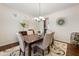 Elegant dining room featuring a stylish chandelier, seating for six, and warm natural light at 1893 S Sinova S Ave, Gilbert, AZ 85295