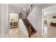 Inviting foyer with tile flooring, stairway with wrought iron spindles, and a view into the dining room at 1893 S Sinova S Ave, Gilbert, AZ 85295