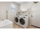 Laundry room features a utility sink, folding table and washer/dryer at 1893 S Sinova S Ave, Gilbert, AZ 85295