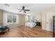 Spacious main bedroom with a ceiling fan, wood flooring, and a window offering ample natural light at 1893 S Sinova S Ave, Gilbert, AZ 85295