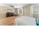 A dresser is situated in the main bedroom that includes wood flooring and a ceiling fan at 1893 S Sinova S Ave, Gilbert, AZ 85295