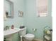 Powder room featuring a pedestal sink and toilet with beadboard at 1893 S Sinova S Ave, Gilbert, AZ 85295