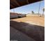 View of the backyard with a dirt yard, grass, and surrounding neighborhood at 1950 E Wier Ave, Phoenix, AZ 85040