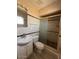 Bright bathroom with a shower, toilet, and sink with cabinet storage underneath at 1950 E Wier Ave, Phoenix, AZ 85040