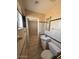 Bright bathroom with a shower, toilet, and sink with cabinet storage underneath at 1950 E Wier Ave, Phoenix, AZ 85040