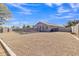 An expansive gravel backyard with a fenced pool and a view of the home's exterior at 20837 N 23Rd Pl, Phoenix, AZ 85024