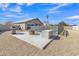 A desert backyard featuring a grill, fire pit, pool enclosure, and decorative cacti at 20837 N 23Rd Pl, Phoenix, AZ 85024