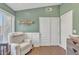 Light-filled Bedroom with neutral chair and white wainscoting at 20837 N 23Rd Pl, Phoenix, AZ 85024