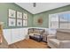 Green-walled Bedroom features wainscoting, neutral accents, and crib at 20837 N 23Rd Pl, Phoenix, AZ 85024