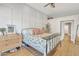 Bright bedroom with wood-style flooring, decorative wall paneling, and a cozy ceiling fan at 20837 N 23Rd Pl, Phoenix, AZ 85024