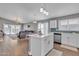 Modern open kitchen with a central island, stainless appliances, and hardwood flooring at 20837 N 23Rd Pl, Phoenix, AZ 85024