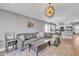 Open-concept living room with a view of the kitchen area and a comfortable sofa at 20837 N 23Rd Pl, Phoenix, AZ 85024