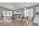 Open-concept living room with vaulted ceilings, recessed lighting, a dining area, and sliding glass doors at 20837 N 23Rd Pl, Phoenix, AZ 85024