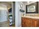 Bathroom featuring a wood vanity with an open view to the shower/tub at 22406 S 173Rd Way, Gilbert, AZ 85298