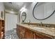 Bathroom with granite counters, dual sinks, decorative mirror and tiled shower/bath at 22406 S 173Rd Way, Gilbert, AZ 85298