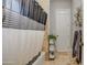 Bathroom with gray and white shower curtain and storage shelves at 22406 S 173Rd Way, Gilbert, AZ 85298