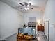 Neutral bedroom with a ceiling fan, window and accent furniture at 22406 S 173Rd Way, Gilbert, AZ 85298