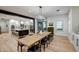 Bright dining room with a view to the kitchen, featuring a large wooden table at 22406 S 173Rd Way, Gilbert, AZ 85298