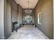 Stylish entryway with decorative bench, stylish tile flooring, and hanging chandelier at 22406 S 173Rd Way, Gilbert, AZ 85298