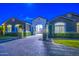 Charming single-story home at dusk featuring a brick driveway and well-maintained landscaping at 22406 S 173Rd Way, Gilbert, AZ 85298