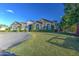 Expansive front yard with lush green lawn and elegant gray facade at 22406 S 173Rd Way, Gilbert, AZ 85298