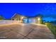 Spacious garage with multiple doors and a paved driveway, complemented by manicured greenery at 22406 S 173Rd Way, Gilbert, AZ 85298