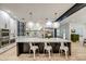 Modern kitchen with a large island, stainless steel appliances, and sleek white cabinets at 22406 S 173Rd Way, Gilbert, AZ 85298