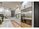 Modern kitchen features white cabinetry, stainless steel appliances, and light wood flooring at 22406 S 173Rd Way, Gilbert, AZ 85298