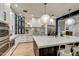 Spacious kitchen with large island, stainless steel appliances, and elegant pendant lighting at 22406 S 173Rd Way, Gilbert, AZ 85298